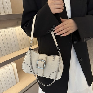 Beige denim canvas underarm bag with silver chain and metal buckle on casual suit