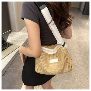 Détail du sac bandoulière en paille tissée main avec sangle en nylon blanc et zip