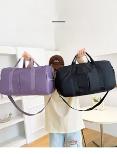 Detail view of large travel bags in purple and black with waterproof nylon fabric and straps