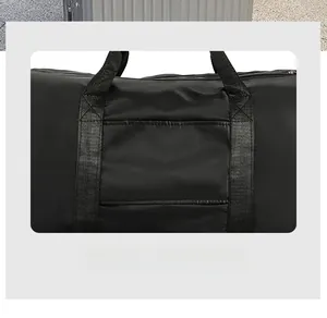 Detail showing the trolley sleeve of the black travel bag for easy luggage attachment