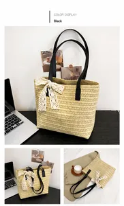 Detail of woven straw tote bag with black leather straps and cream lace bow accent