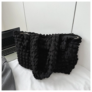 Detail of black bubble texture on large capacity tote bag with zipper closure