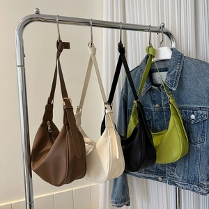 Group of colorful lychee texture hobo shoulder bags hanging on a metal rack