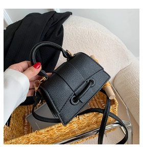 Detailed view of the black pebble leather mini square bag with gold-tone hardware