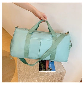 Detail of mint green fitness bag showing durable nylon material and adjustable shoulder strap