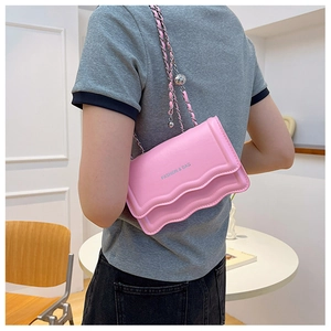 Pink shoulder bag with wave trim, woven chain strap and metal ball decoration