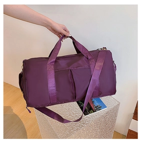Detail of waterproof nylon gym bag in deep purple with reinforced fabric handles