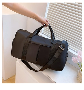 Close-up of black nylon gym bag with dual handles and adjustable shoulder strap