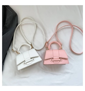Close-up of mini drawstring square bags in white and pink with lychee grain texture