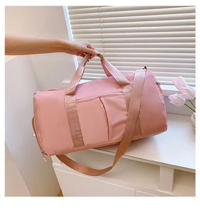 Pink duffel gym bag with waterproof nylon, dual handles and adjustable shoulder strap