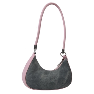 Chic crescent denim shoulder bag with pink leather strap and silver zipper closure