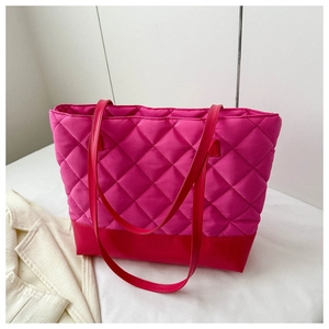 Detailed close-up of fuchsia quilted tote bag with red base and luxury diamond stitching