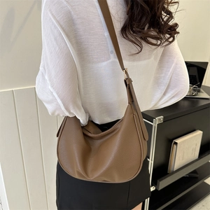 Brown half-moon crossbody bag in lychee texture faux leather with gold buckle detail