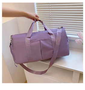 Detailed view of a purple waterproof fitness bag with spacious pockets and nylon straps
