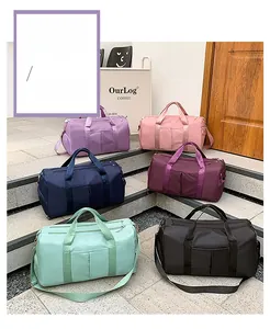 Multiple colorful waterproof nylon travel bags showing various color options and carry straps