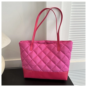 Macro detail of quilted patterns and reinforced base on a pink nylon tote bag