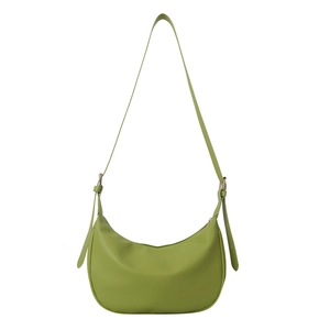 Minimalist light green crescent shoulder bag in lychee texture with adjustable strap