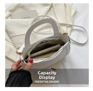 Interior view of white crossbody bag showing storage capacity for phone and wallet