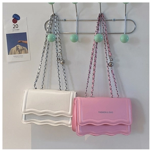 Close-up of wavy flap PU crossbody bag in pink and white with golden chain strap