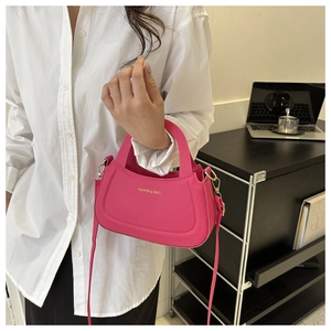 Detailed view of pink PU leather crossbody bag with gold Fashion & Bags lettering