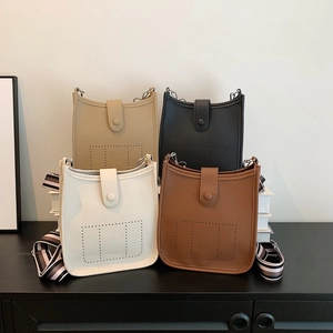 Litchi pattern bucket bags in four colors with striped woven shoulder straps