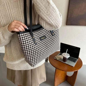 Fashion houndstooth tote bag for women with black leather straps in a lifestyle office setting