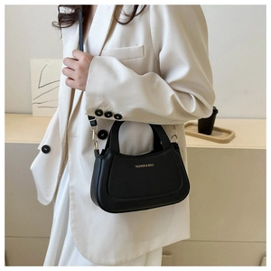 Detail of black semi-circle crossbody bag with gold Fashion & Bags lettering and hardware