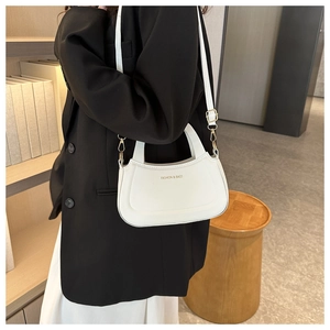 Detail of white leather crossbody bag with top handle and gold Fashion & Bags logo