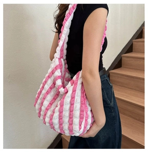 Detailed macro view of pink and white checkered seersucker shoulder bag fabric