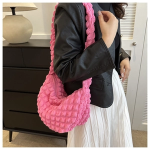 Detail of pink bubble texture shoulder bag showing high-elastic popcorn fabric finish