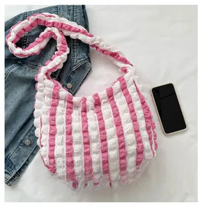 Detail of pink and white striped gathered fabric shoulder bag with ruffled edges
