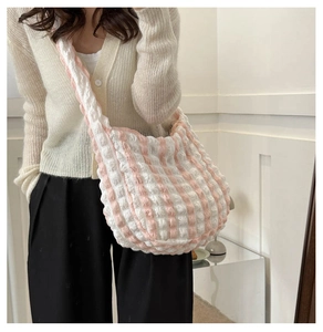 Detail showing pink and white checkered bubble fabric texture of a large capacity tote bag