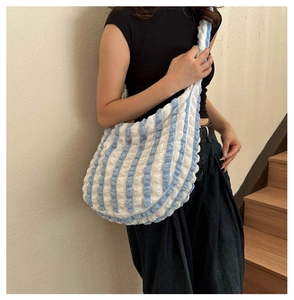 Blue and white plaid bubble texture shoulder bag styled on a model in casual setting