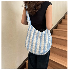 Detail of blue and white striped popcorn bubble texture on large capacity tote bag