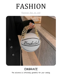 Detail of creative white basketball shaped crossbody bag with gold chain and letter print
