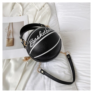 Detail of creative basketball-shaped crossbody bag with gold chain and pebbled leather texture