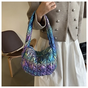Detail of laser quilted puffer bag with gradient metallic finish and rhombus stitching