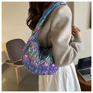 Iridescent quilted puffy hobo bag with a metallic finish and crescent shape shown on shoulder