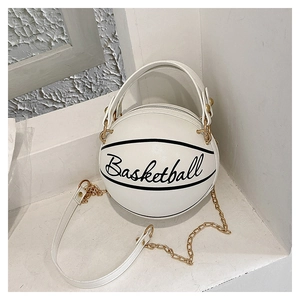 Detail of creative white basketball shaped handbag with gold chain and black lettering