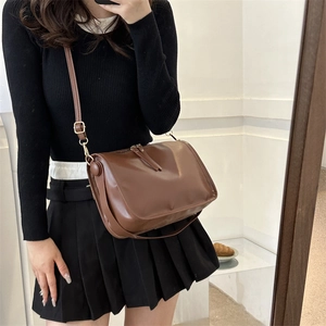 Minimalist deep brown large capacity tote bag shown as a crossbody on model
