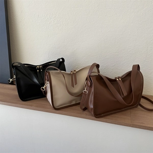 Three minimalist leather crossbody bags in black, beige, and brown with tassel zippers