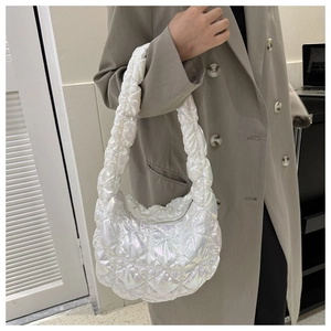 Detail of white quilted cloud bag featuring laser glossy finish and chic puffer texture