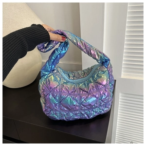 Detail of holographic quilted texture and vibrant gradient metallic finish on shoulder bag