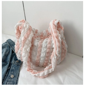 Detail of pink and white bubble texture fabric on a cloud-shaped shoulder bag
