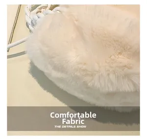 Macro shot of plush faux fur texture on a soft white crossbody bag with delicate details