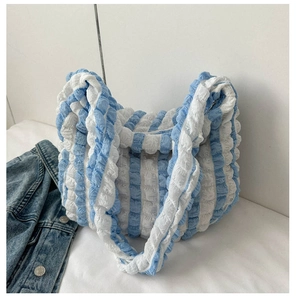 Detail of blue and white vertical stripe tote with unique 3D bubble popcorn texture