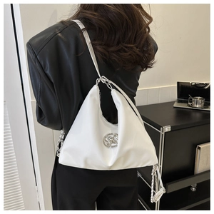 Chic white hobo bag shown from a side view on a model with metallic chain detailing