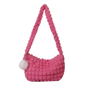 Hot pink ruched shoulder bag with textured bubble fabric and white pompom pendant
