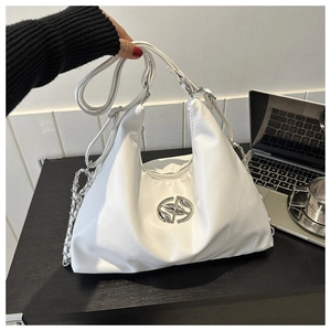 Close-up of white crescent shoulder bag with silver logo and chic chain detail