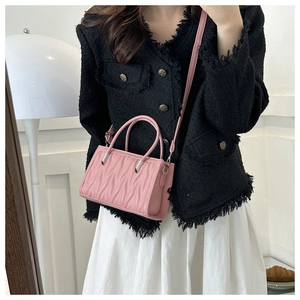 Pink quilted leather crossbody bag with pleated V-texture and silver hardware accents